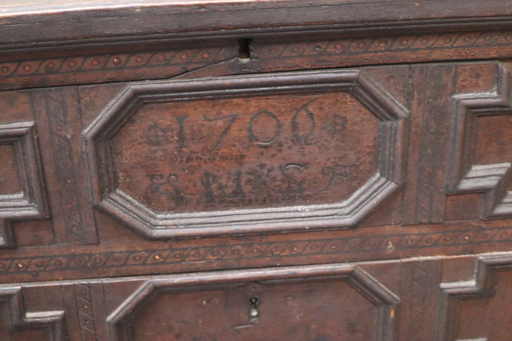 An early 18th century oak chest with hinged top, width 84cm, depth 45cm, height 85cm